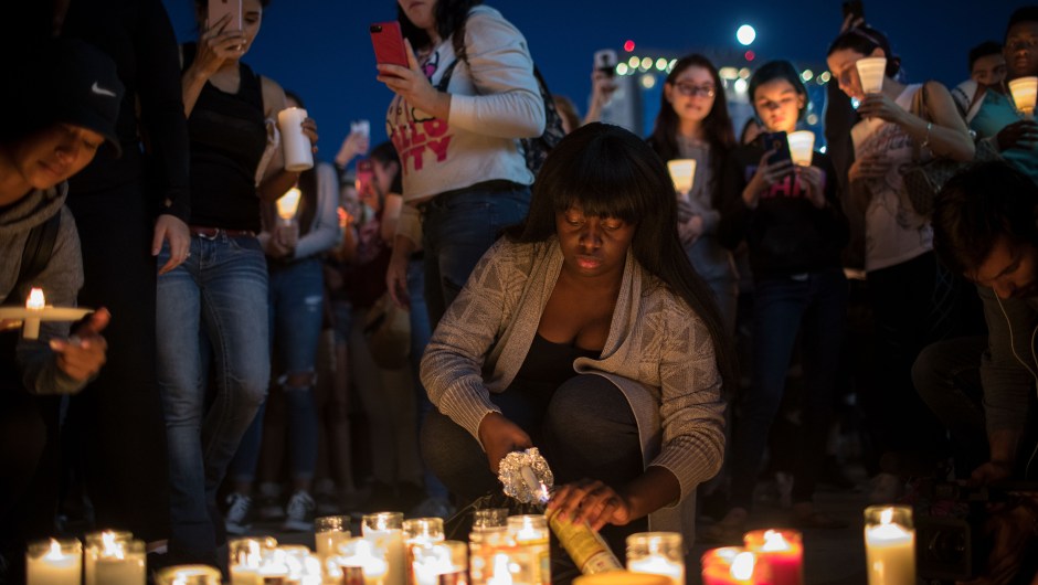 LAS VEGAS, NV - OCTOBER 2: Mourners light candles during a vigil at the corner of Sahara Avenue and Las Vegas Boulevard for the victims of Sunday night's mass shooting, October 2, 2017 in Las Vegas, Nevada. Late Sunday night, a lone gunman killed more than 50 people and injured more than 500 people after he opened fire on a large crowd at the Route 91 Harvest Festival, a three-day country music festival. The massacre is one of the deadliest mass shooting events in U.S. history. (Photo by Drew Angerer/Getty Images)