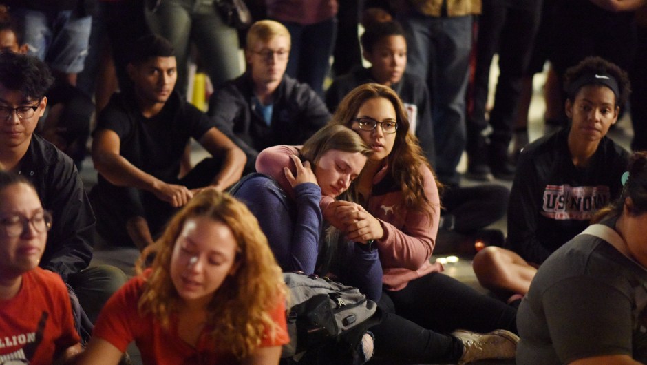 People attend a candlelight vigil at the University of Las Vegas student union October 2, 2017, after a gunman killed at least 58 people and wounded more than 500 others when he opened fire on a country music concert in Las Vegas, Nevada late October 1, 2017. / AFP PHOTO / Robyn Beck (Photo credit should read ROBYN BECK/AFP/Getty Images)