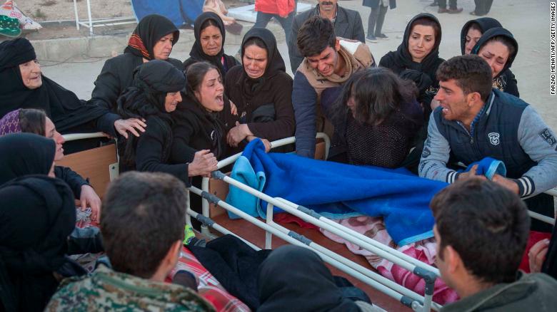 Iranians mourn over the body of a victim following a 7.3-magnitude earthquake in Sarpol-e Zahab in Iran's western province of Kermanshah on November 13, 2017. More than 200 people were killed and hundreds more injured when the 7.3-magnitude earthquake shook the mountainous Iran-Iraq border triggering landslides that hindered rescue efforts, officials said. / AFP PHOTO / TASNIM NEWS / Farzad MENATI (Photo credit should read FARZAD MENATI/AFP/Getty Images)