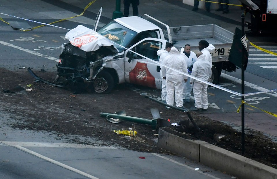 TOPSHOT - Investigators inspect a truck following a shooting incident in New York on October 31, 2017. Several people were killed and numerous others injured in New York on Tuesday after a vehicle plowed into a pedestrian and bike path in Lower Manhattan, police said. "The vehicle struck multiple people on the path," police tweeted. "The vehicle continued south striking another vehicle. The suspect exited the vehicle displaying imitation firearms & was shot by NYPD." / AFP PHOTO / DON EMMERT (Photo credit should read DON EMMERT/AFP/Getty Images)