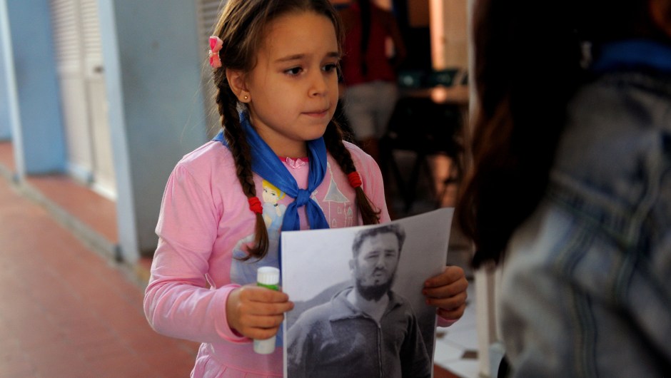 A Cuban primary school student works on a collage with images of late Cuban leader Fidel Castro in Havana, on November 23, 2017. Cuba commemorates on November 25 the first anniversary of the death of Fidel Castro, focused on an electoral process that will imply a presidential change, in a framework of economic regression, hostility from the United States, and stagnation in its reforms. / AFP PHOTO / YAMIL LAGE (Photo credit should read YAMIL LAGE/AFP/Getty Images)
