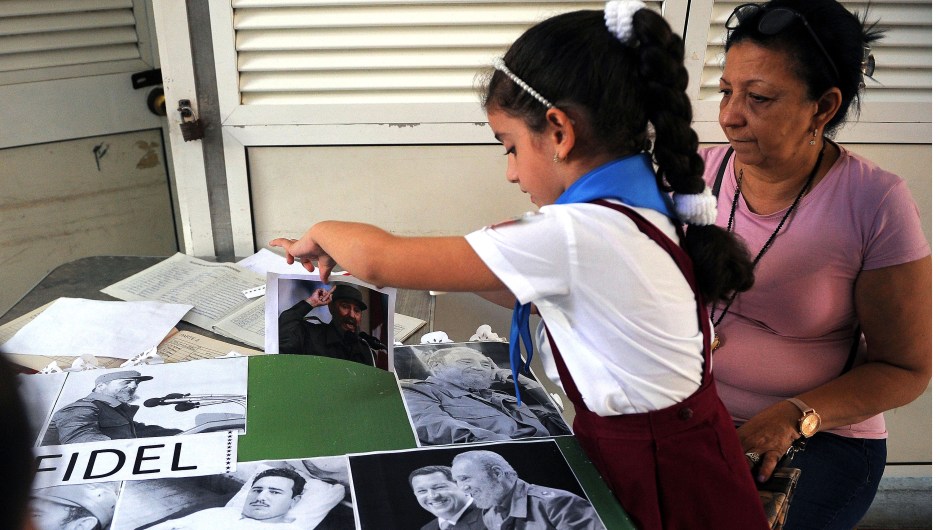 A Cuban primary school student works on a collage with images of late Cuban leader Fidel Castro in Havana, on November 23, 2017. Cuba commemorates on November 25 the first anniversary of the death of Fidel Castro, focused on an electoral process that will imply a presidential change, in a framework of economic regression, hostility from the United States, and stagnation in its reforms. / AFP PHOTO / YAMIL LAGE (Photo credit should read YAMIL LAGE/AFP/Getty Images)
