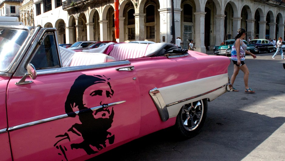 View of a classic American car decorated with the image of late Cuban leader Fidel Castro in Havana, on November 24, 2017. Cuba commemorates on November 25 the first anniversary of the death of Fidel Castro, focused on an electoral process that will imply a presidential change, in a framework of economic regression, hostility from the United States, and stagnation in its reforms. / AFP PHOTO / YAMIL LAGE (Photo credit should read YAMIL LAGE/AFP/Getty Images)