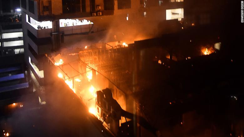 TOPSHOT - EDITORS NOTE: Graphic content / A general view of a building on fire where a rooftop party was being held in Mumbai early on December 29, 2017. At least 14 people were killed when a huge blaze tore through a popular restaurant in Mumbai early December 29, police said, in the latest disaster to raise concerns over fire safety in India. / AFP PHOTO / - (Photo credit should read -/AFP/Getty Images)