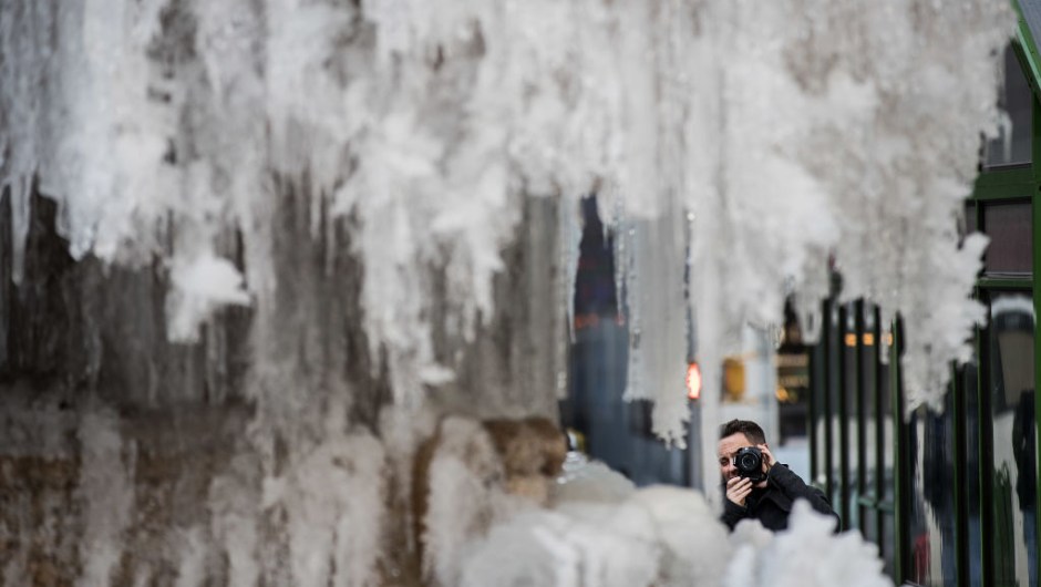 NEW YORK, NY - JANUARY 03: A man photographs a frozen fountain in Bryant Park, January 3, 2018 in New York City. New York City was placed under a winter storm watch Wednesday as a major weather system is expected to threaten the area with heavy snow and powerful wind Wednesday night into Thursday. (Photo by Drew Angerer/Getty Images)
