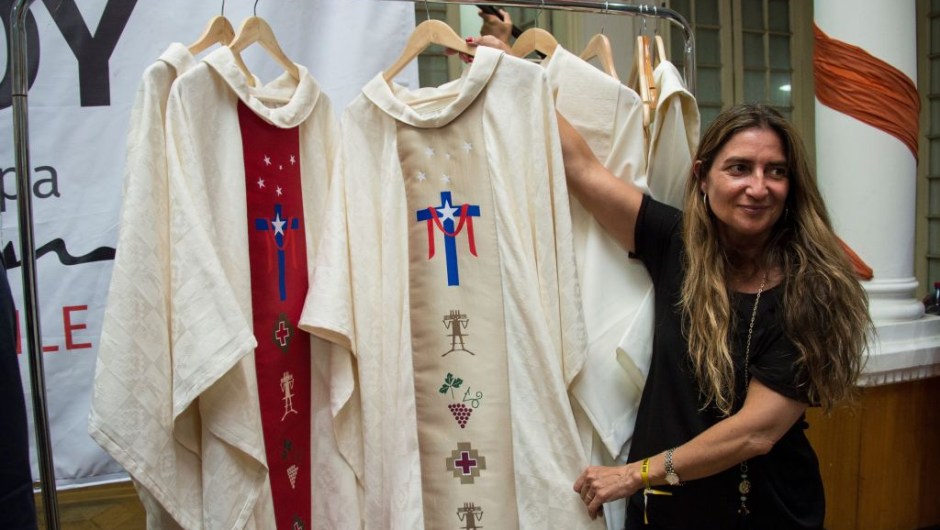 An employee of the episcopate shows the papal vestments to be used by Pope Francis during his upcoming visit to Chile, in Santiago, on January 8, 2018. Pope Francis will be visiting Chile from January 15 to 18. / AFP PHOTO / Martin BERNETTI (Photo credit should read MARTIN BERNETTI/AFP/Getty Images)