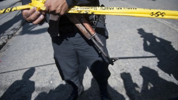 A policeman stands guard at the crime scene after Francisco Palomo, an attorney Guatemala's former dictator Efrain Rios Montt, was shot dead in Guatemala City on June 3, 2015. Palomo was driving in his car when gunmen unloaded a hail of bullets, striking him at least 12 times, and killing him in broad daylight in a busy commercial area of Guatemala City, said firefighters spokesman Raul Hernandez. AFP PHOTO Johan ORDONEZ (Photo credit should read JOHAN ORDONEZ/AFP/Getty Images)