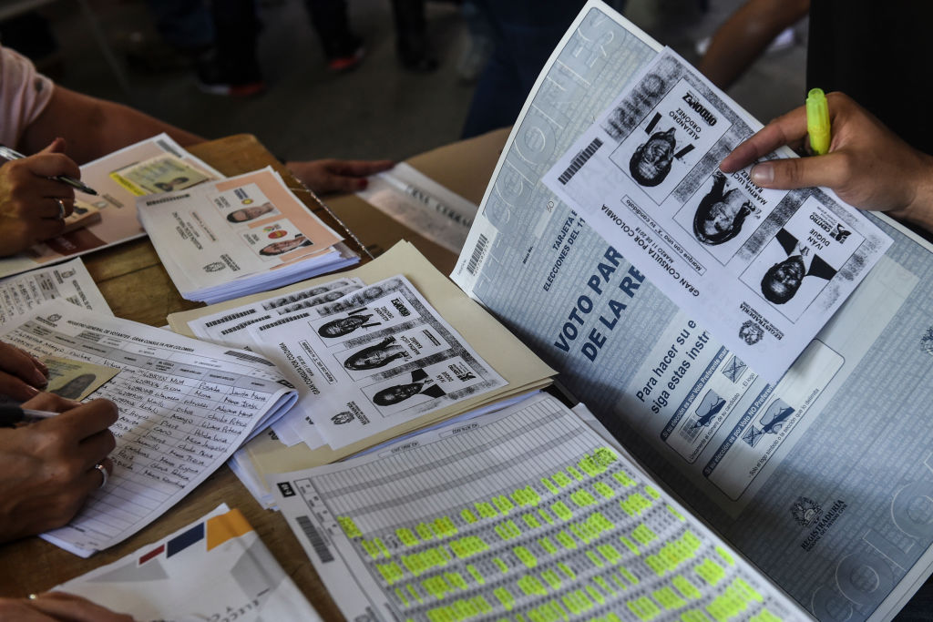 Photocopies of ballots for one of the two main political blocs holding primary elections at the same time of the parliamentary elections in Colombia, are available at a polling station after the originals ran out, in Medellin, Antioquia Department, Colombia, on March 11, 2018. Colombians went to the polls Sunday to elect a new Congress with a resurgent right, bitterly opposed to a peace deal that allows leftist former rebels to participate, expected to poll strongly. The election is set to be the calmest in half a century of conflict in Colombia, with the former rebel movement FARC spurning jungle warfare for politics, and the ELN -- the country's last active rebel group -- observing a ceasefire. / AFP PHOTO / Joaquin SARMIENTO (Photo credit should read JOAQUIN SARMIENTO/AFP/Getty Images)