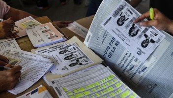 Photocopies of ballots for one of the two main political blocs holding primary elections at the same time of the parliamentary elections in Colombia, are available at a polling station after the originals ran out, in Medellin, Antioquia Department, Colombia, on March 11, 2018. Colombians went to the polls Sunday to elect a new Congress with a resurgent right, bitterly opposed to a peace deal that allows leftist former rebels to participate, expected to poll strongly. The election is set to be the calmest in half a century of conflict in Colombia, with the former rebel movement FARC spurning jungle warfare for politics, and the ELN -- the country's last active rebel group -- observing a ceasefire. / AFP PHOTO / Joaquin SARMIENTO (Photo credit should read JOAQUIN SARMIENTO/AFP/Getty Images)