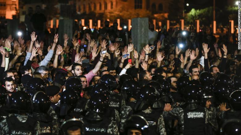 Manifestantes jordanos levantan sus manos en protestas frente a la oficina del primer ministro. (Crédito: KHALIL MAZRAAWI/AFP/Getty Images)
