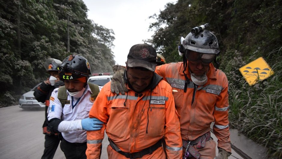 TOPSHOT - A volunteer firefighter cries after leaving El Rodeo village in Escuintla department, 35 km south of Guatemala City on June 3, 2018, following the eruption of the Fuego Volcano. (Photo by ORLANDO ESTRADA / AFP) (Photo credit should read ORLANDO ESTRADA/AFP/Getty Images)