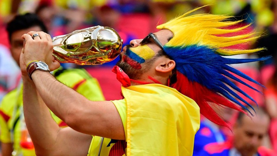 TOPSHOT - A Colombia fan poses with a replica World Cup in the crowd before kick off of the Russia 2018 World Cup Group H football match between Poland and Colombia at the Kazan Arena in Kazan on June 24, 2018. (Photo by Luis Acosta / AFP) / RESTRICTED TO EDITORIAL USE - NO MOBILE PUSH ALERTS/DOWNLOADS (Photo credit should read LUIS ACOSTA/AFP/Getty Images)