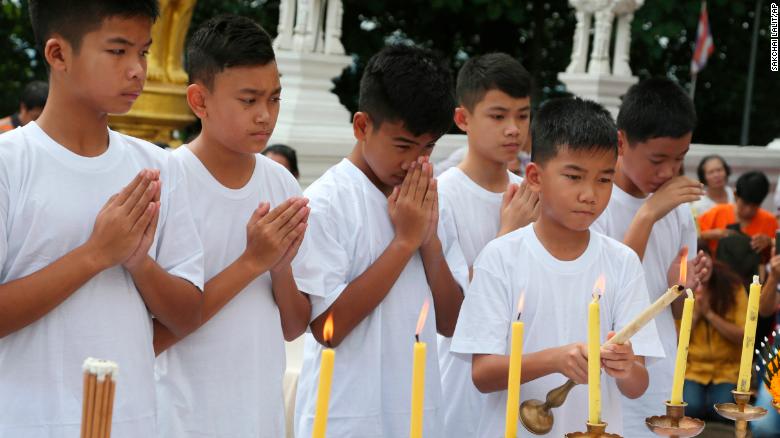 Chanin Vibulrungruang light a candle with members of the rescued soccer team attend a Buddhist ceremony that is believed to extend the lives of its attendees as well as ridding them of dangers and misfortunes in Mae Sai district, Chiang Rai province, northern Thailand, Tuesday, July 24, 2018. Eleven of the boys and their coach rescued last week from the flooded Tham Luang cave attend a merit making ceremony at a buddhist temple. The boys are also expected to have their heads shaved in the afternoon in preparation for their ordination as buddhist novices. (AP Photo/Sakchai Lalit)