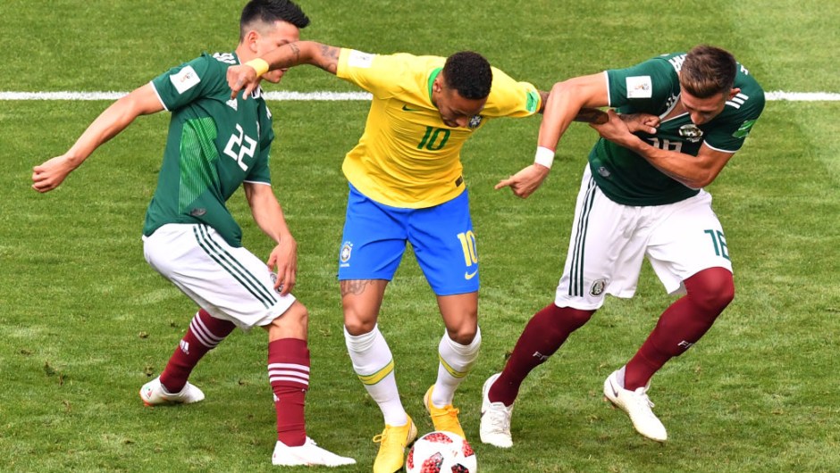 Brazil's forward Neymar (C) is marked by Mexico's forward Hirving Lozano (L) and Mexico's midfielder Hector Herrera during the Russia 2018 World Cup round of 16 football match between Brazil and Mexico at the Samara Arena in Samara on July 2, 2018. (Photo by SAEED KHAN / AFP) / RESTRICTED TO EDITORIAL USE - NO MOBILE PUSH ALERTS/DOWNLOADS (Photo credit should read SAEED KHAN/AFP/Getty Images)