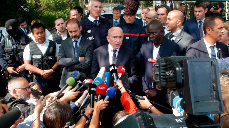 French Interior Minister Gerard Collomb, center, answers reporters after a knife attack Thursday, Aug. 23, 2018 in Trappes, west of Paris. A man flagged by French authorities as a suspected radical killed his mother and sister and seriously injured another woman in a knife attack Thursday that was quickly claimed by the Islamic State group. (AP Photo/Michel Euler)