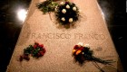 Flower are placed on the tomb of former Spanish dictator Francisco Franco inside the basilica at the the Valley of the Fallen monument near El Escorial, outside Madrid, Friday, Aug. 24, 2018. Spain's center-left government has approved legal amendments that it says will ensure the remains of former dictator Gen. Francisco Franco can soon be dug up and removed from a controversial mausoleum. (AP Photo/Andrea Comas)