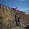 TOPSHOT - A group of Central American migrants climb the border fence between Mexico and the United States, near El Chaparral border crossing, in Tijuana, Baja California State, Mexico, on November 25, 2018. - Hundreds of migrants attempted to storm a border fence separating Mexico from the US on Sunday amid mounting fears they will be kept in Mexico while their applications for a asylum are processed. An AFP photographer said the migrants broke away from a peaceful march at a border bridge and tried to climb over a metal border barrier in the attempt to enter the United States. (Photo by Pedro PARDO / AFP) (Photo credit should read PEDRO PARDO/AFP/Getty Images)