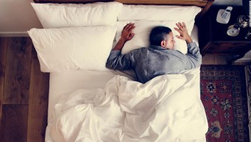 French man sleeping alone on bed; Shutterstock ID 1070512514; Job: sleep