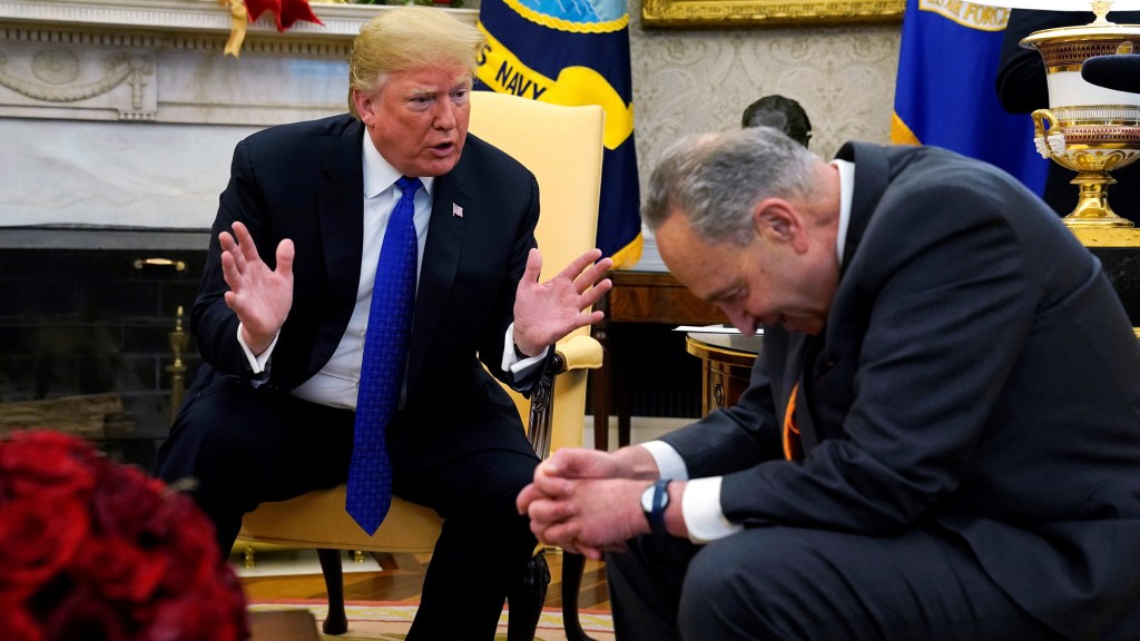 U.S. President Donald Trump speaks with Senate Democratic Leader Chuck Schumer (D-NY) in the Oval Office of the White House in Washington, U.S., December 11, 2018. REUTERS/Kevin Lamarque