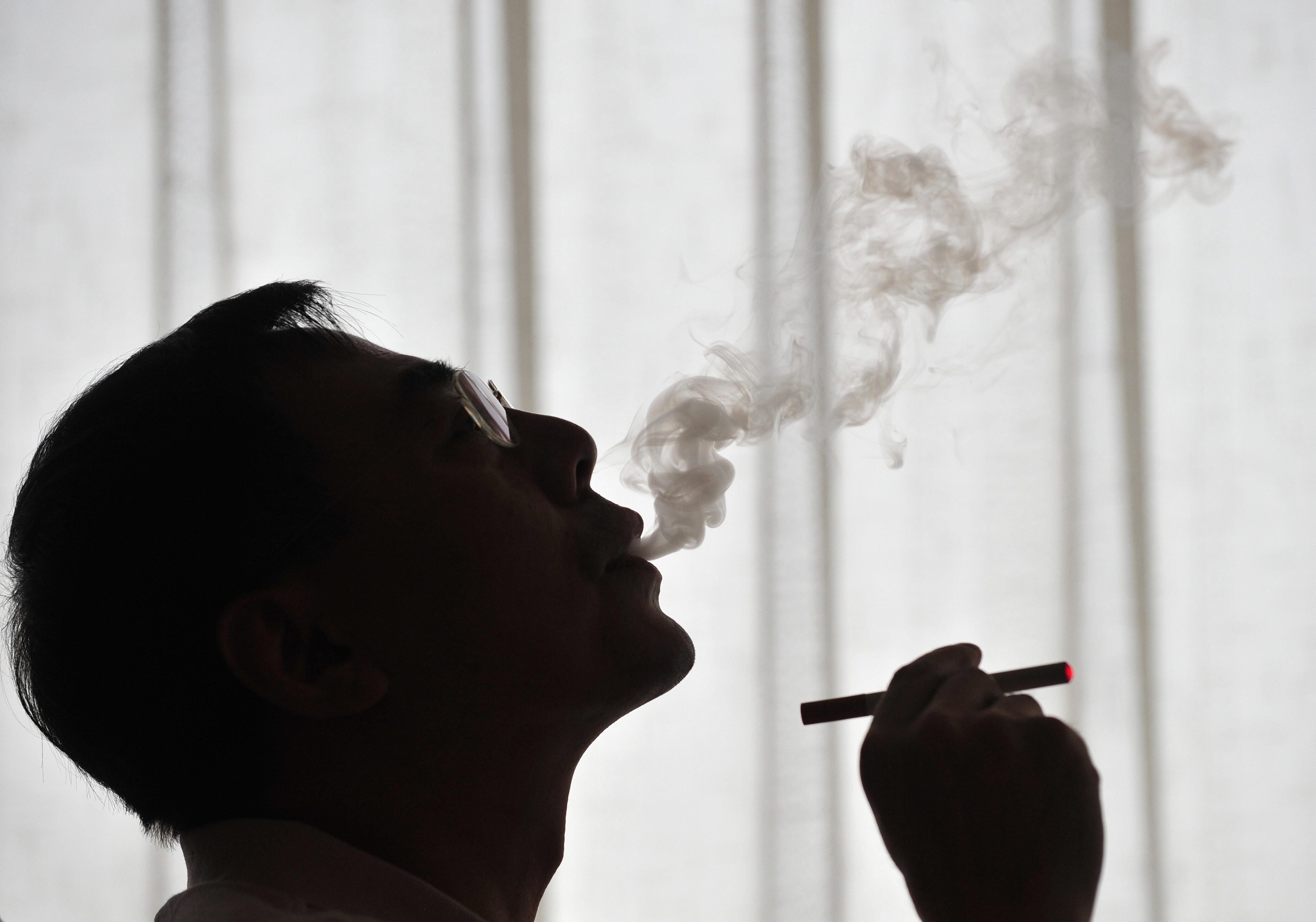 The inventor of the electronic cigarette, Hon Lik smokes his invention in Beiijng on May 25, 2009. Also known as an 'e-cigarette', the battery-powered device is designed as an alternative to cigarettes, cigars and pipes, and provides inhaled doses of nicotine by delivering a vaporized propylene glycol/nicotine solution, while also providing the physical sensation and flavors similar to inhaled tobacco smoke. With 350 million tobacco smokers nationwide, China will join the world in observing World No Tobacco Day on May 31. AFP PHOTO/Frederic J. BROWN (Photo credit should read FREDERIC J. BROWN/AFP/Getty Images)