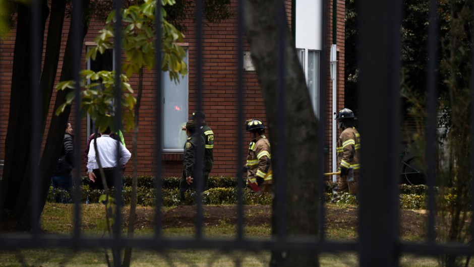 Security forces and firefighters work at the site of an apparent car bomb attack on a police cadet training school in Bogota, that left at least four people dead and 10 injured on January 17, 2019. - "It seems there was a car bomb inside the General Santander School," said the city's mayor, Enrique Penalosa. (Photo by JUAN BARRETO / AFP) (Photo credit should read JUAN BARRETO/AFP/Getty Images)