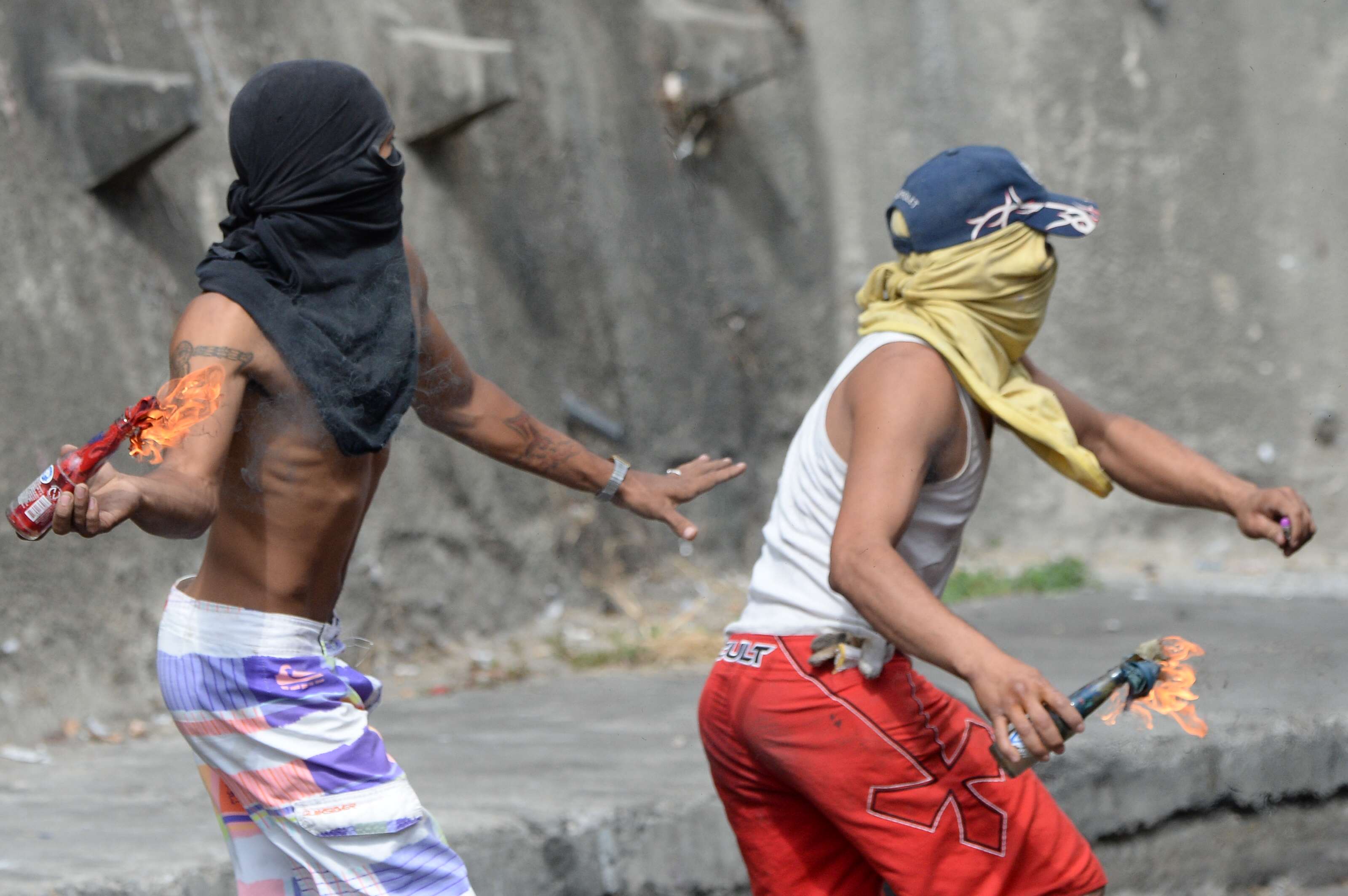 Anti-government demonstrators throw Molotov cocktails during clashes with police and troops in the surroundings of a National Guard command post in Cotiza, in northern Caracas, on January 21, 2019. - A group of soldiers rose up against Venezuela's President Nicolas Maduro at a command post in northern Caracas on Monday, but were quickly arrested after posting an appeal for public support in a video, the government said. (Photo by Federico PARRA / AFP) (Photo credit should read FEDERICO PARRA/AFP/Getty Images)