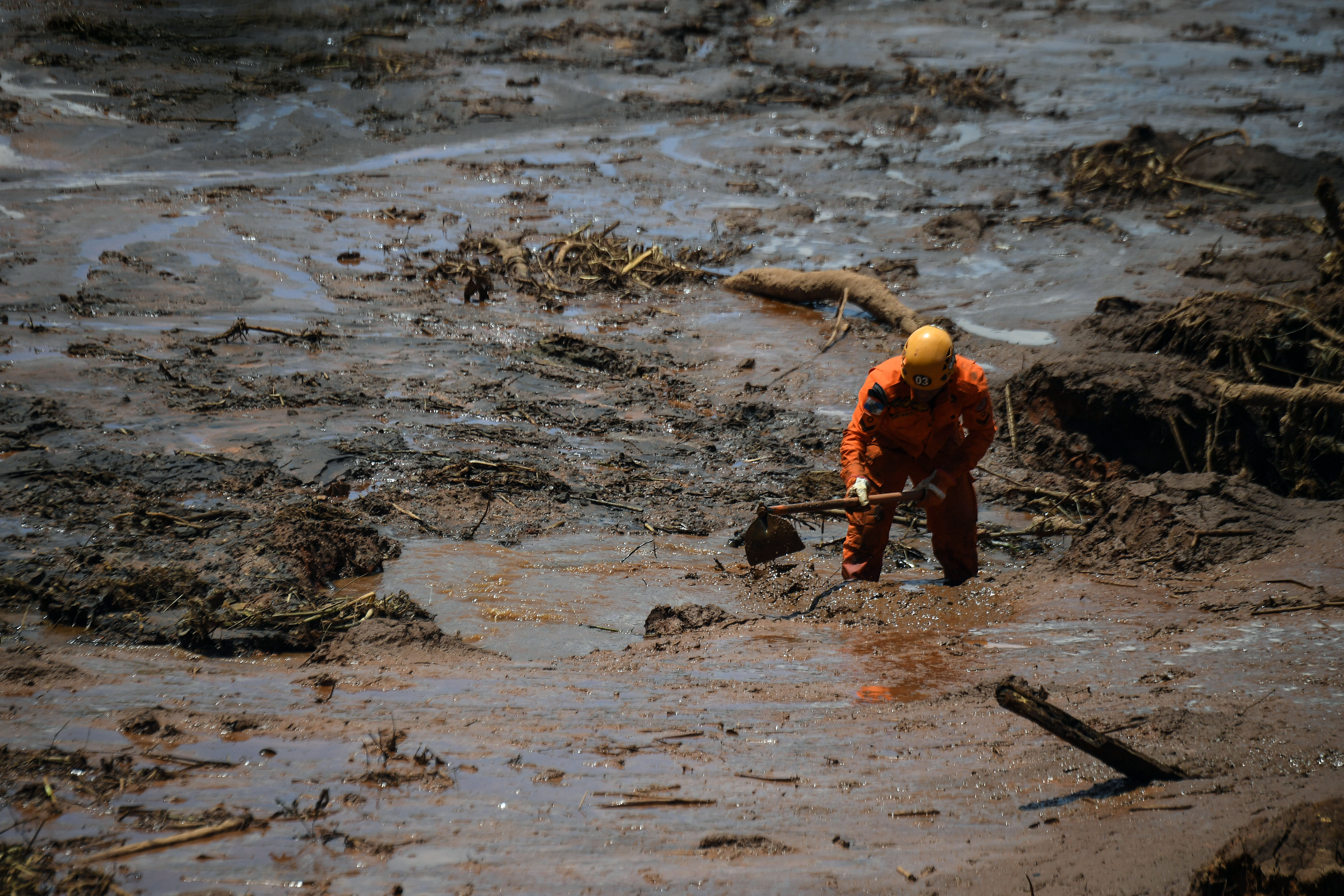 A rescuer works in the search for victims, four days after the collapse of a dam at an iron-ore mine belonging to Brazil's giant mining company Vale near the town of Brumadinho, state of Minas Gerias, southeastern Brazil, on January 28, 2019. - The search for survivors intensified on Monday, on its fourth day, with the support of an Israeli contingent, after communities were devastated by a dam collapse that killed at least 60 people at a Brazilian mining complex -- with hopes fading for 292 still missing. A barrier at the site burst on Friday, spewing millions of tons of treacherous sludge and engulfing buildings, vehicles and roads. (Photo by Mauro Pimentel / AFP) (Photo credit should read MAURO PIMENTEL/AFP/Getty Images)