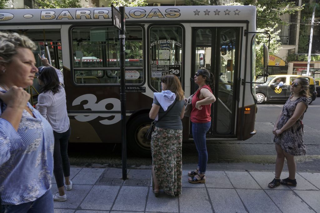 Commuters wait for a bus in Buenos Aires, on January 3, 2018. The Argentine government announced Wednesday 30% to 60% hikes in public transport fares in Buenos Aires, in its effort to reduce the fiscal deficit. / AFP PHOTO / EITAN ABRAMOVICH (Photo credit should read EITAN ABRAMOVICH/AFP/Getty Images)