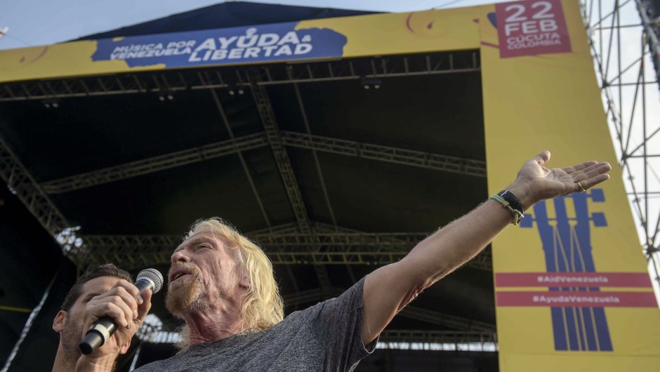 British billionaire Richard Branson speaks before the "Venezuela Aid Live" concert which he organized to raise money for the Venezuelan relief effort, at Tienditas International Bridge in Cucuta, Colombia, on February 22, 2019. - Venezuela's political tug-of-war morphs into a battle of the bands on Friday, with dueling government and opposition pop concerts ahead of a weekend showdown over the entry of badly needed food and medical aid. (Photo by RAUL ARBOLEDA / AFP) (Photo credit should read RAUL ARBOLEDA/AFP/Getty Images)