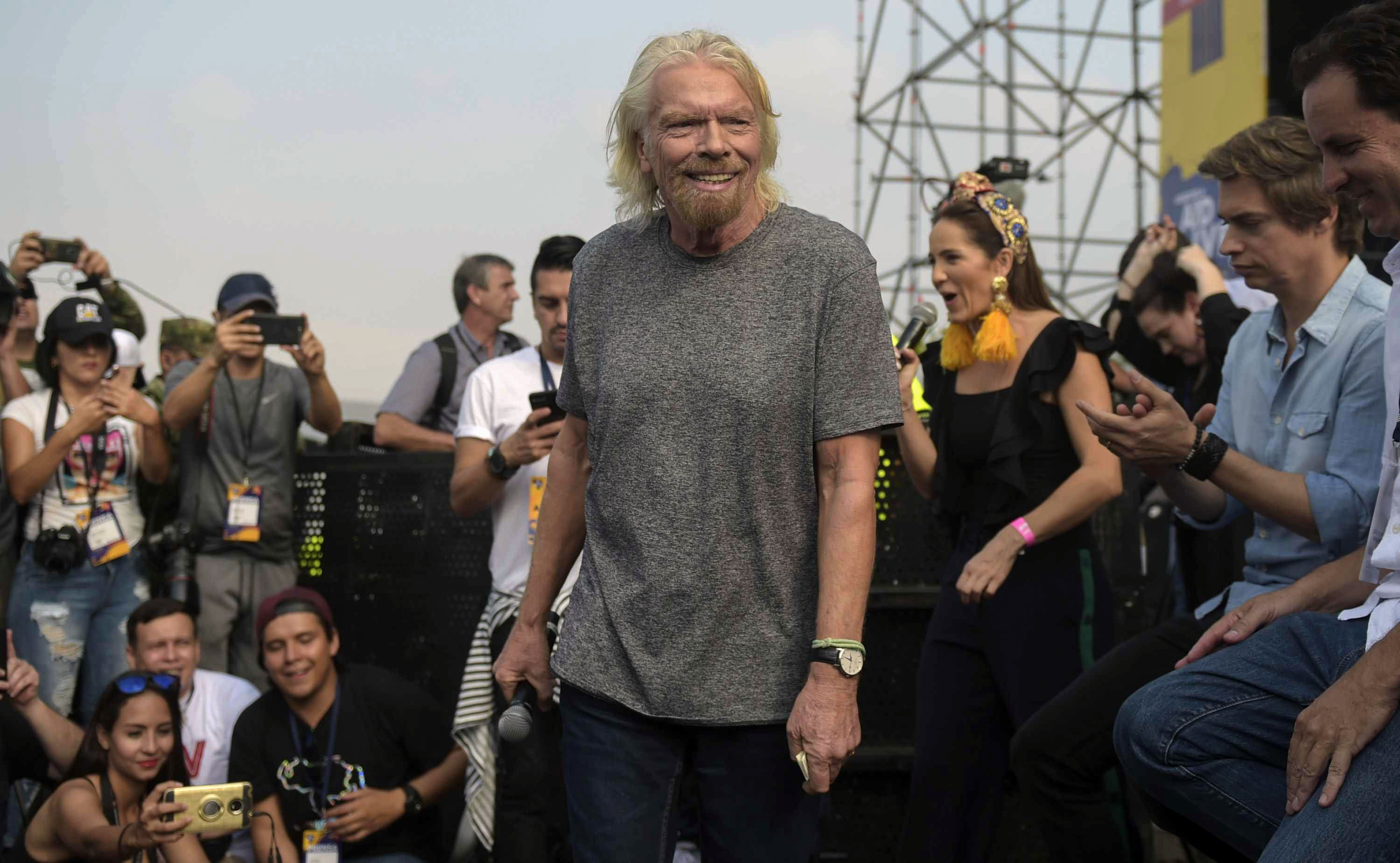 British billionaire Richard Branson (C) is pictured before the "Venezuela Aid Live" concert which he organized to raise money for the Venezuelan relief effort, at Tienditas International Bridge in Cucuta, Colombia, on February 22, 2019. - Venezuela's political tug-of-war morphs into a battle of the bands on Friday, with dueling government and opposition pop concerts ahead of a weekend showdown over the entry of badly needed food and medical aid. (Photo by RAUL ARBOLEDA / AFP) (Photo credit should read RAUL ARBOLEDA/AFP/Getty Images)