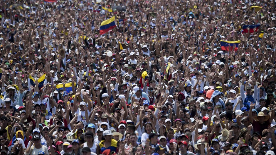 People attend "Venezuela Aid Live" concert, organized to raise money for the Venezuelan relief effort at Tienditas International Bridge in Cucuta, Colombia, on February 22, 2019. - Venezuela's political tug-of-war morphs into a battle of the bands on Friday, with dueling government and opposition pop concerts ahead of a weekend showdown over the entry of badly needed food and medical aid. (Photo by RAUL ARBOLEDA / AFP) (Photo credit should read RAUL ARBOLEDA/AFP/Getty Images)