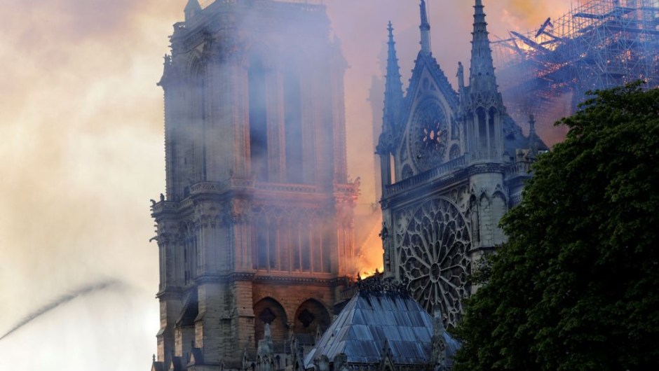 The landmark Notre-Dame Cathedral is engulfed by flames in central Paris on April 15, 2019. - A huge fire swept through the roof of the famed Notre-Dame Cathedral in central Paris on April 15, 2019, sending flames and huge clouds of grey smoke billowing into the sky. The flames and smoke plumed from the spire and roof of the gothic cathedral, visited by millions of people a year. A spokesman for the cathedral told AFP that the wooden structure supporting the roof was being gutted by the blaze. (Photo by Geoffroy VAN DER HASSELT / AFP) (Photo credit should read GEOFFROY VAN DER HASSELT/AFP/Getty Images)