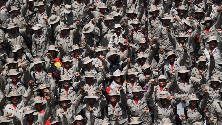 TOPSHOT - Members of Venezuela's Bolivarian Militia attend a pro-government rally on May Day in Caracas on May 1, 2019. - Pro- and anti-government rallies were due to take place in Venezuela, a day after violent clashes erupted in the capital following opposition leader Juan Guido's call on the military to rise up against Maduro, who claimed the insurrection had failed. (Photo by Yuri CORTEZ / AFP) (Photo credit should read YURI CORTEZ/AFP/Getty Images)