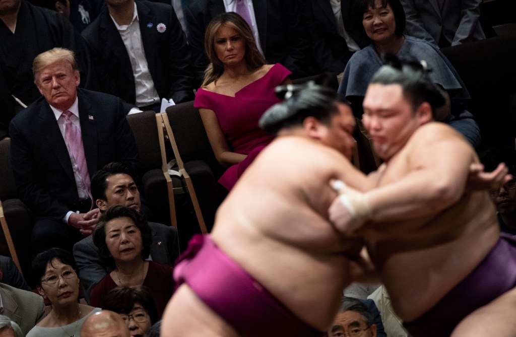 TOPSHOT - US President Donald Trump (L) First Lady Melania Trump (C) and Japan's Prime Minister Shinzo Abe' Akie Abe (R) watch a sumo battle during the Summer Grand Sumo Tournament in Tokyo on May 26, 2019. (Photo by Brendan SMIALOWSKI / AFP) (Photo credit should read BRENDAN SMIALOWSKI/AFP/Getty Images)