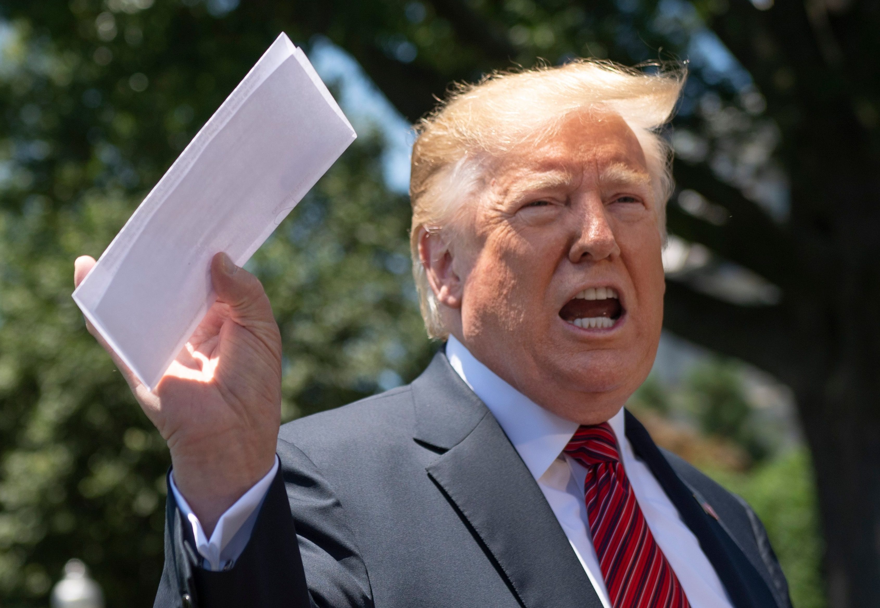 US President Donald Trump holds piece of paper saying its his deal with Mexico as he speaks with reporters at the White House, in Washington, DC, on June 11, 2019. - Trump did not show the paper to reporters. (Photo by Jim WATSON / AFP) (Photo credit should read JIM WATSON/AFP/Getty Images)