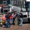 Handcuffed female workers are escorted into a bus for transportation to a processing center following a raid by U.S. immigration officials at a Koch Foods Inc., plant in Morton, Miss., Wednesday, Aug. 7, 2019. U.S. immigration officials raided several Mississippi food processing plants on Wednesday and signaled that the early-morning strikes were part of a large-scale operation targeting owners as well as employees. (AP Photo/Rogelio V. Solis)