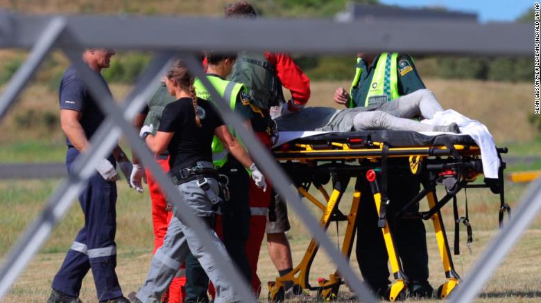 Emergency services attend to an injured person arriving at the Whakatane Airfield after the volcanic eruption Monday, Dec. 9, 2019, on White Island, New Zealand. (Alan Gibson/New Zealand Herald via AP)