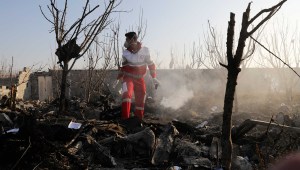 A rescue worker searches the scene where an Ukrainian plane crashed in Shahedshahr, southwest of the capital Tehran, Iran, Wednesday, Jan. 8, 2020. A Ukrainian airplane carrying 176 people crashed on Wednesday shortly after takeoff from Tehran's main airport, killing all onboard. (AP Photo/Ebrahim Noroozi)