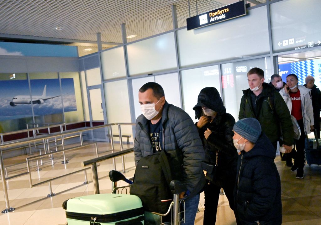 Ukrainian tourists walk in the arrival hall of the Internatioanal Boryspil airport outside Kiev after their plane landed from China on January 30, 2020. - The first out of four special flights will be held on January 30, 2020 in order to evacuate hundreds of Ukrainian tourists from China as a deadly coronavirus outbreak grows. With no regular flights between Ukraine and China, two Ukrainian airlines, SkyUp and Ukraine International Airlines, provide charter transportation for holidaymakers to the seaside resort of Sanya on the Hainan island, but they announced a suspension of transportation after the epidemic has killed more than 130 people and spread around the world. (Photo by Sergei SUPINSKY / AFP) (Photo by SERGEI SUPINSKY/AFP via Getty Images)