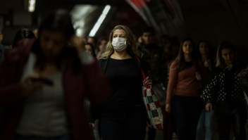 SAO PAULO, BRAZIL - FEBRUARY 27: A woman wears a protective mask as walking on the subway on February 27, 2020 in São Paulo, Brazil. The Brazilian Ministry of Health confirmed yesterday the first case of Coronavirus in the country. A man in the state of São Paulo was diagnosed with COVID-19. The first Covid-19 disease appeared in late 2019 in China's Wuhan province. (Photo by Victor Moriyama/Getty Images)