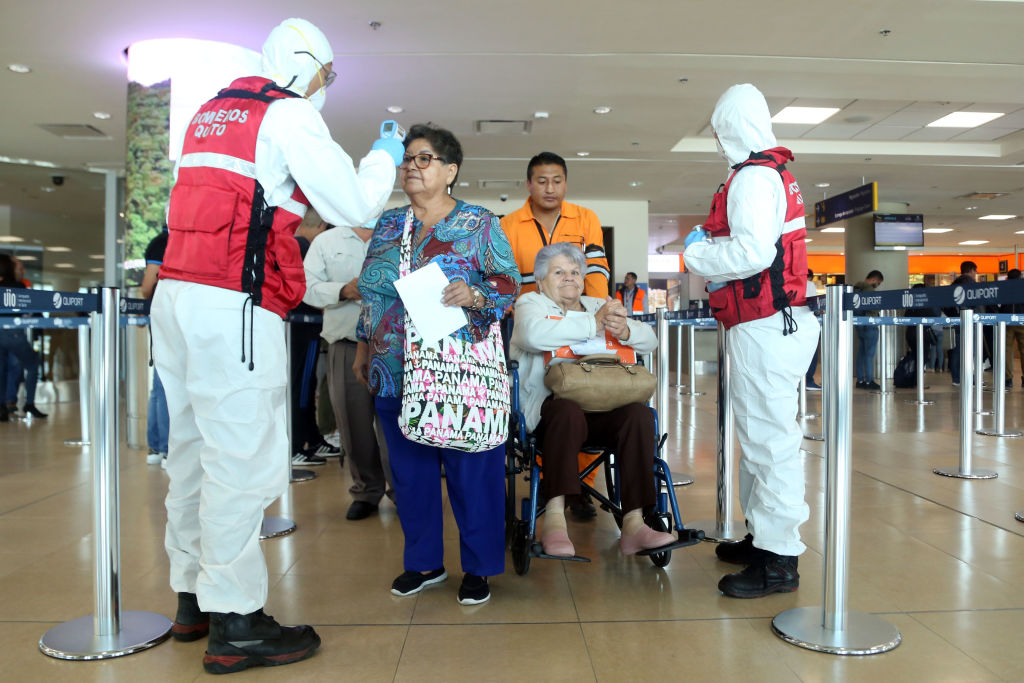 Health workers check passengers arriving at Mariscal Sucre International Airport regarding the spread of the COVID-19 virus worldwide, in Quito, on March 1, 2020. - Ecuador confirmed on the eve its first case of the COVID-19. (Photo by Cristina Vega Rhor / AFP) (Photo by CRISTINA VEGA RHOR/AFP via Getty Images)
