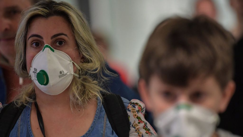Passengers wearing masks as a precautionary measure to avoid contracting the new coronavirus, COVID-19, arrive on a flight from Italy at Guarulhos International Airport, in Guarulhos, Sao Paulo, Brazil on March 2, 2020. - The death toll from the new coronavirus epidemic surpassed 3,000 on Monday. The virus has now infected more than 89,000, spread to over 60 countries and threatens to cause a global economic slowdown -- after first emerging in China late last year. (Photo by Nelson ALMEIDA / AFP) (Photo by NELSON ALMEIDA/AFP via Getty Images)
