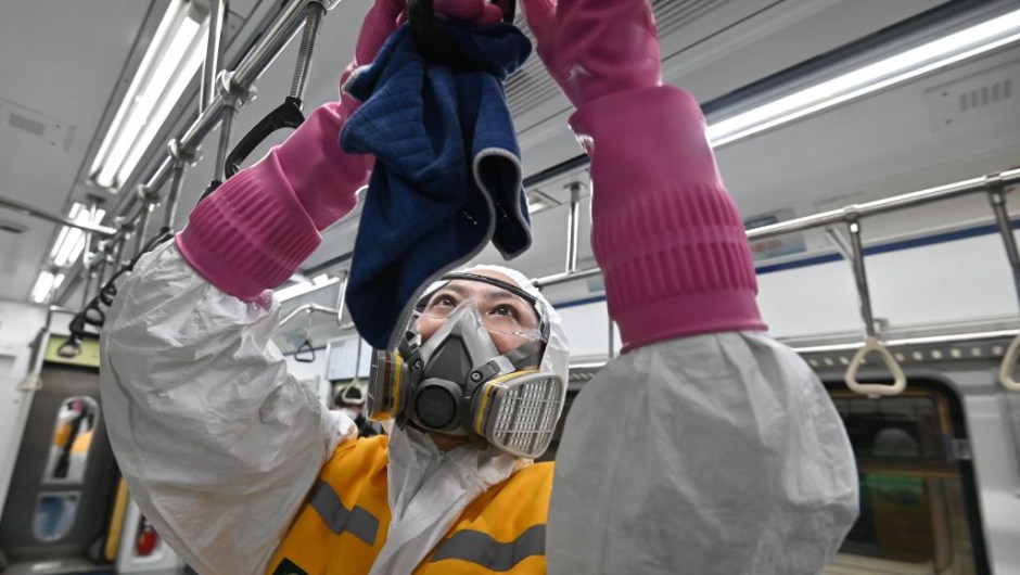 TOPSHOT - A worker wearing protective gear disinfects a train to help prevent the spread of the COVID-19 coronavirus, at Seoul Metro Gunja Train Depot in Seoul on March 11, 2020. - South Korea announced its first rise in new coronavirus cases for five days on March 11, following a run of declines that have raised hopes the outbreak is coming under control. A total of 242 infections were confirmed on March 10 taking the South's total to 7,755. (Photo by Jung Yeon-je / AFP) (Photo by JUNG YEON-JE/AFP via Getty Images)