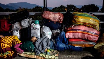 A Venezuelan attempting to return to his country due to the novel coronavirus COVID-19 pandemic, sleeps in the Simon Bolivar International Bridge in Cucuta, Colombia, on April 26, 2020, after the Venezuelan government closed the way to some 300 Venezuelans coming home. (Photo by Schneyder MENDOZA / AFP) (Photo by SCHNEYDER MENDOZA/AFP via Getty Images)